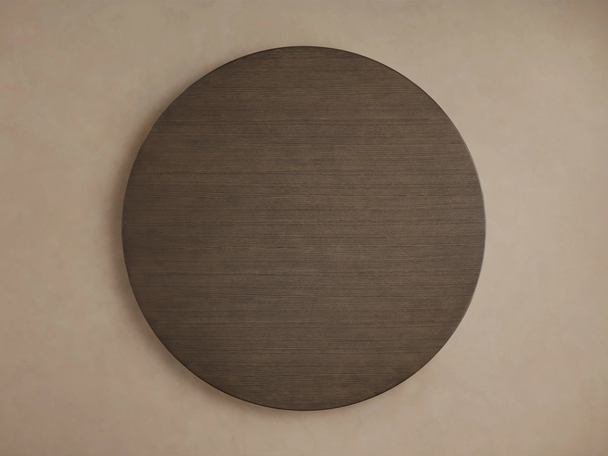 Round chestnut oak tabletop of Saint Germain Dining Table with visible wood grain, angled view showing smooth finish.