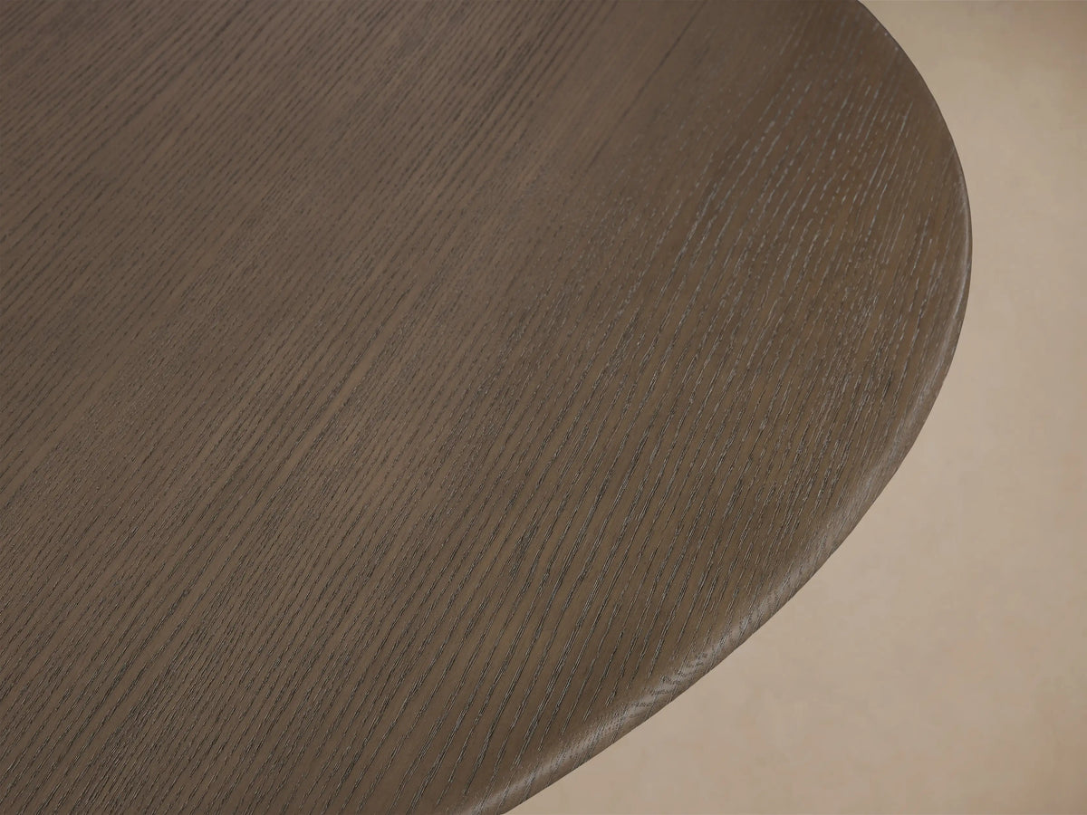 Close-up of the Chestnut wood grain on the round top of the Saint Germain 60" Round Chestnut Top Dining Table.