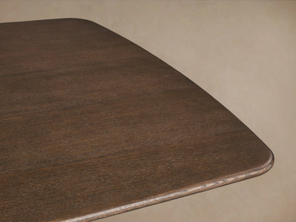 Close-up of Saint Germain dining table corner, featuring a solid oak top with rounded edges in a deep Chestnut finish.
