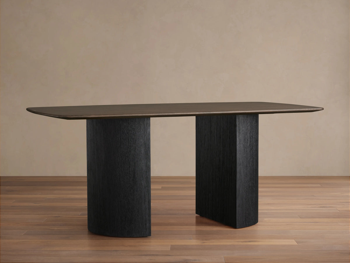 Saint Germain Wood Dining Table with oval solid oak top in Ebony finish, featuring two curved ebony-finished bases.