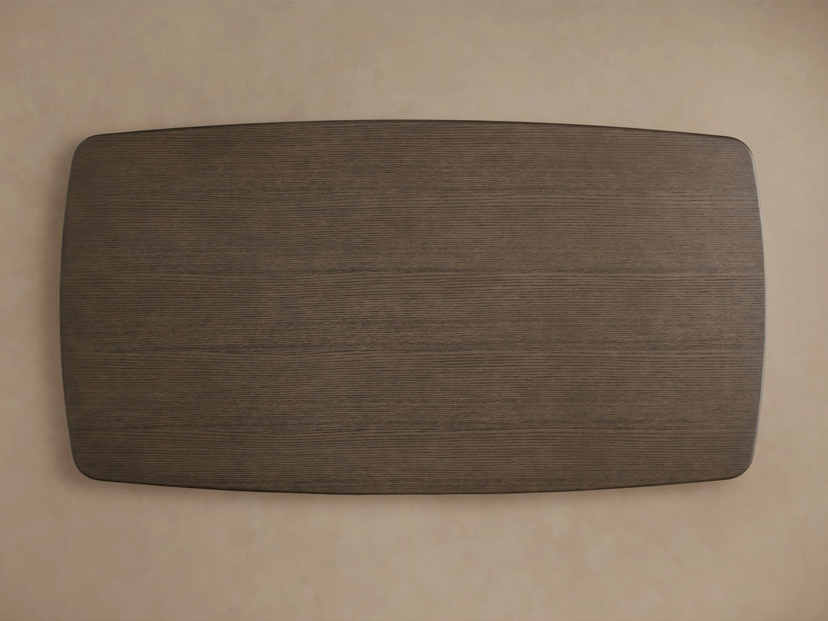 Corner view of the Saint Germain Wood Dining Table's solid oak tabletop with a smooth Chestnut finish, set against a neutral background.
