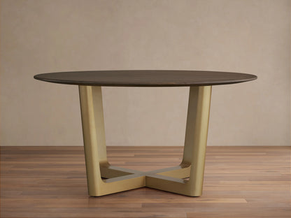 Saint Germain Round Wood Dining Table with a dark oak top on a brass-finished, cross-shaped Rennes base, set on wooden floor.