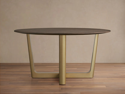 Saint Germain Round Wood Dining Table with a dark oak top on a brass-finished, cross-shaped Rennes base, set on wooden floor.