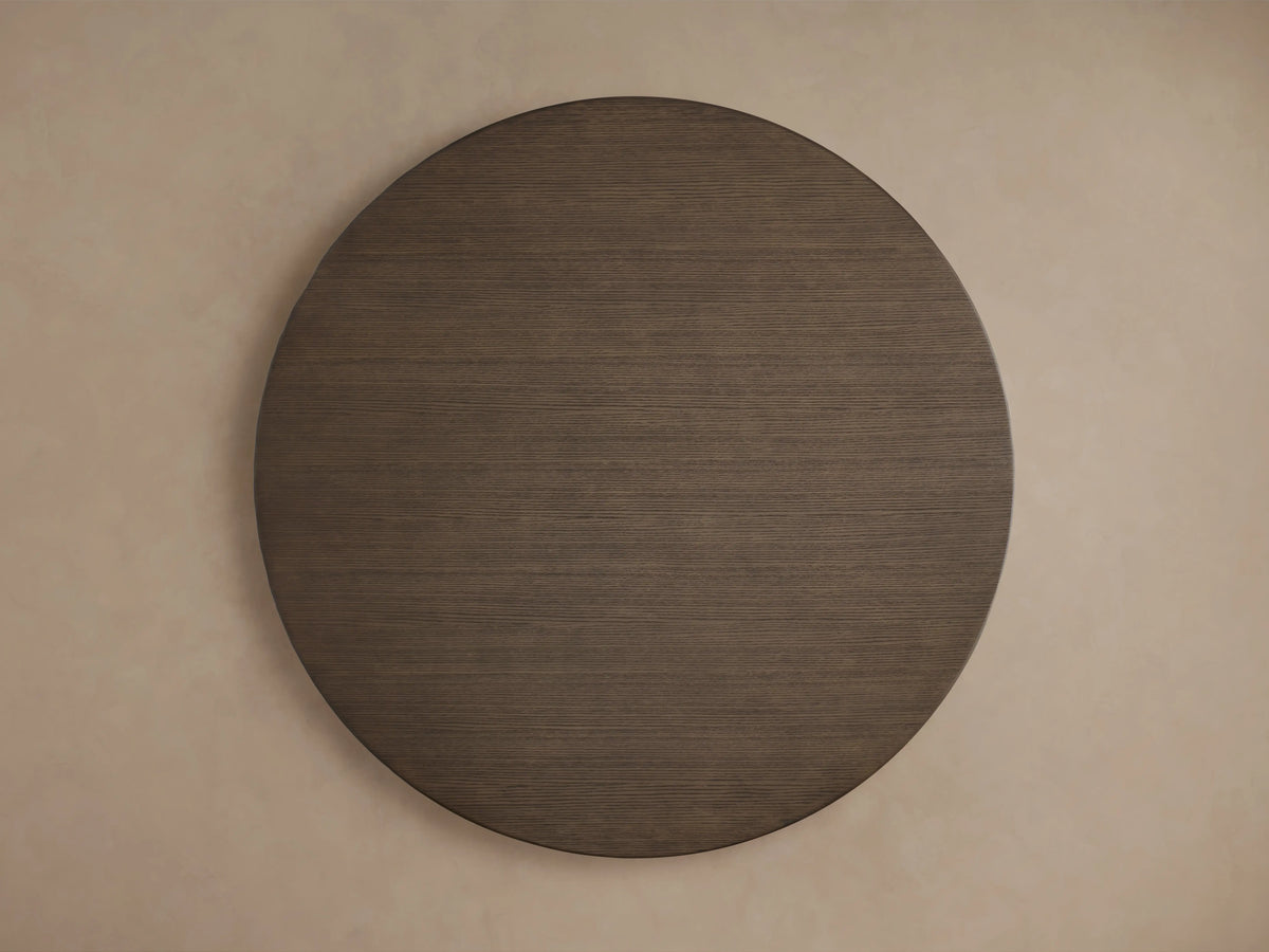 Round wooden tabletop of the Saint Germain Dining Table, showcasing a rich, dark wood grain finish with smooth edges.