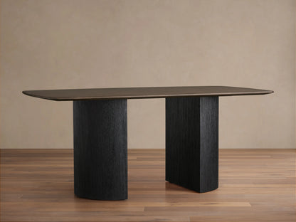Wooden dining table with a rectangular oak veneer top in dark finish, supported by two wide, cylindrical bases in matching dark hue.