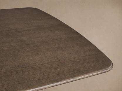 Saint Germain Wood Dining Table featuring a smooth, solid oak veneer tabletop with a rounded edge in a Chestnut finish.