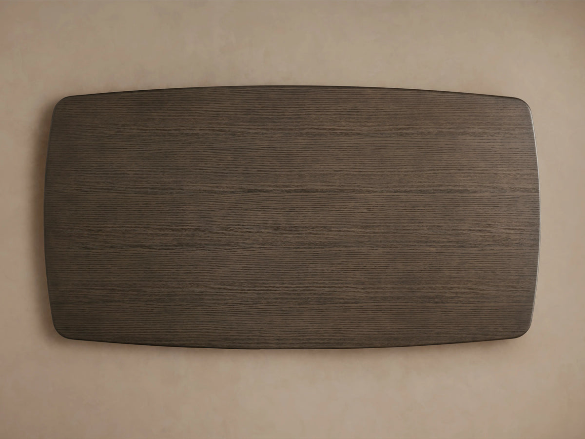Saint Germain Wood Dining Table with a dark oak top and sleek steel Launette base, set on a wooden floor.