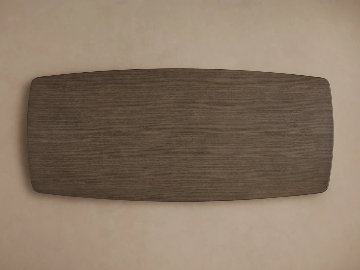 Edge of Saint Germain Wood Dining Table with dark oak finish, showing smooth, rounded corners and visible wood grain texture.