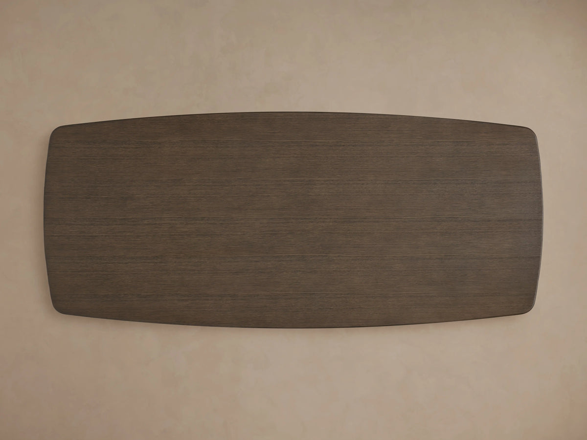 Corner view of the Saint Germain Wood Top Dining Table with a smooth, brown oak surface and beveled edge, against a neutral background.