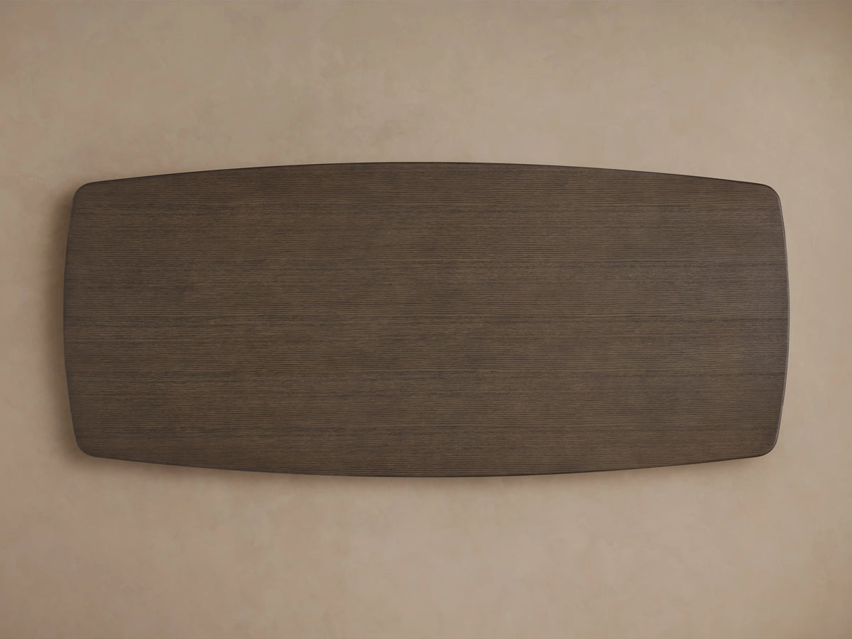 Dining table with wood top in chestnut finish, corner view showing smooth surface and subtle wood grain, soft beige background.