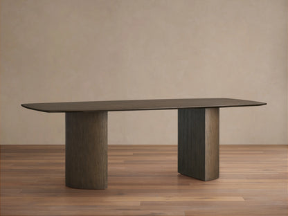 Saint Germain Wood Dining Table with an oval top and two cylindrical Dauphine bases, finished in a dark wood on hardwood floor.
