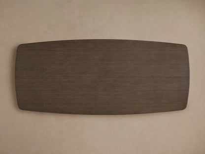 Corner view of the Saint Germain Wood Dining Table showcasing a smooth, dark brown oak finish with rounded edges.