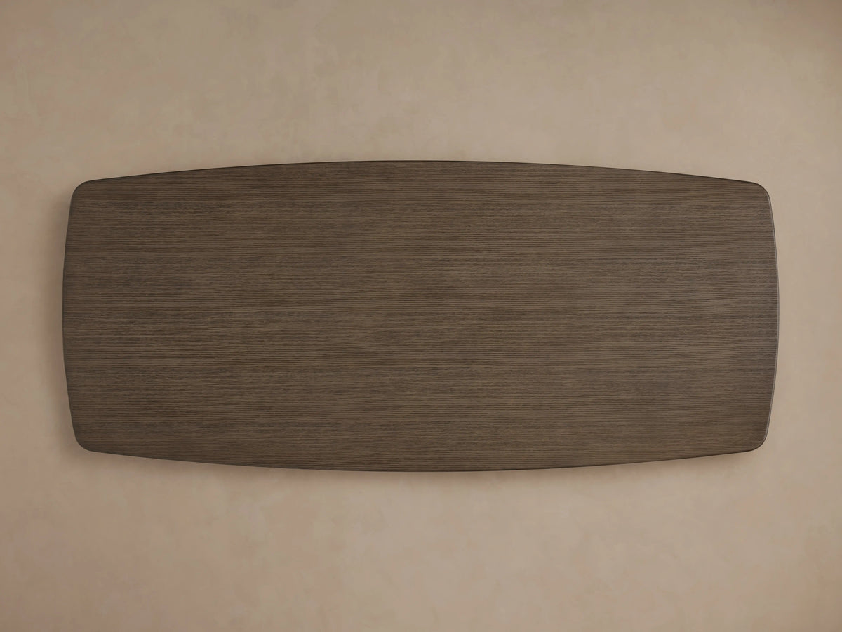 Corner view of the Saint Germain Wood Dining Table, showing a solid oak tabletop in a dark Ebony finish against a beige background.