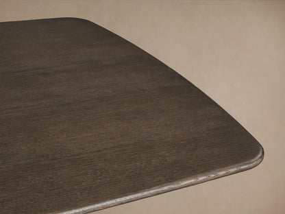 Saint Germain Wood Dining Table with a dark finish, featuring a sleek rectangular top and unique curved Rennes base in Ebony.