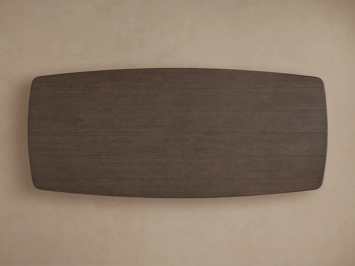 Close-up of Saint Germain Wood Dining Table's dark ebony oak top, showing visible grain and a smooth rounded corner.