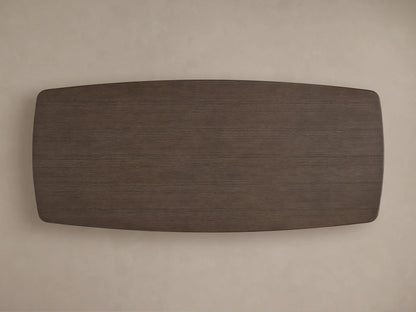 Close-up of the Saint Germain Wood Dining Table's dark brown oak tabletop, showing rich wood grain and a softly rounded edge.