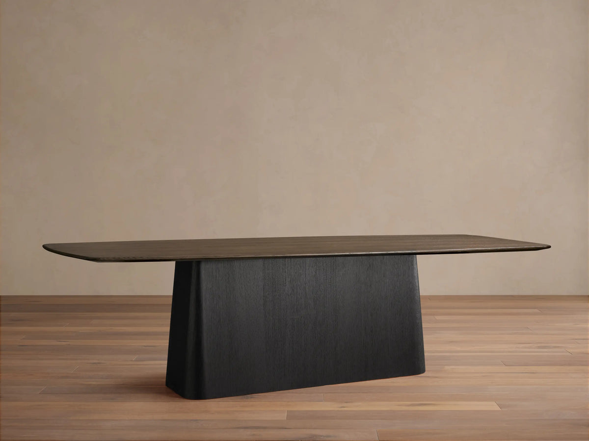 Saint Germain Wood Dining Table with Toulouse Base, dark ebony rectangular top, subtle rounded corners, solid black tapered base.