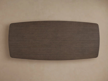 Close-up of the Saint Germain Wood Dining Table, showing its dark wood grain surface and smooth, rounded corner.