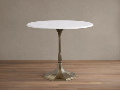 Front view of the Clemence Bistro Table with a white Carrara marble top and a brass-toned tulip-style pedestal base.