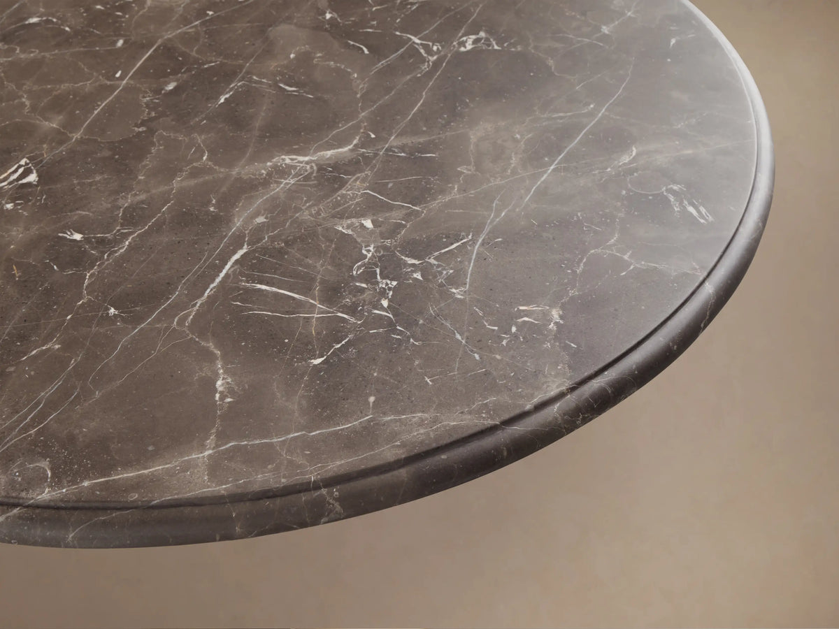 Front view of Clemence Bistro Table, featuring a dark espresso brown marble top and a brass-toned tulip pedestal base.