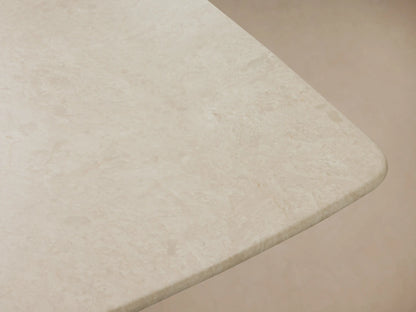 Saint Germain Stone Dining Table with a light, rectangular stone top and a dark, wood-grained Toulouse base on wood floor.