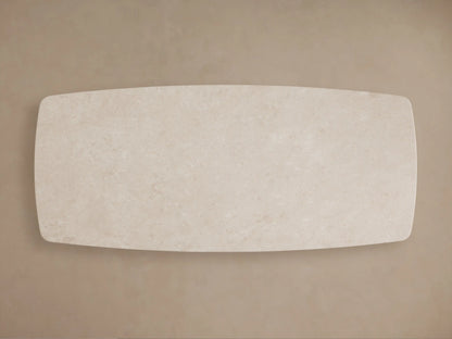 Cream marble tabletop of Saint Germain Stone Dining Table, showing natural veining and a smooth, rounded edge.