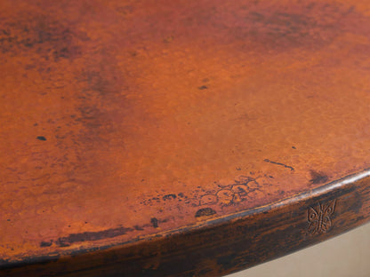 Recycled Metal Bistro Table with Wade Base. Round, rustic reddish-brown metal top on a dark bronze pedestal base.