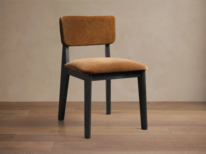 Front view of the Corrado Dining Side Chair with a dark ash wood frame and golden brown upholstered seat and backrest.