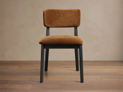 Front view of the Corrado Dining Side Chair with a dark ash wood frame and golden brown upholstered seat and backrest.