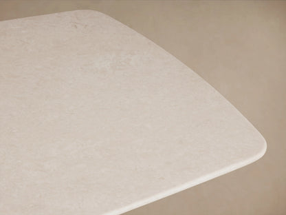 Saint Germain Dining Table corner with creamy marble top, rounded edges, subtle veining on a neutral background.