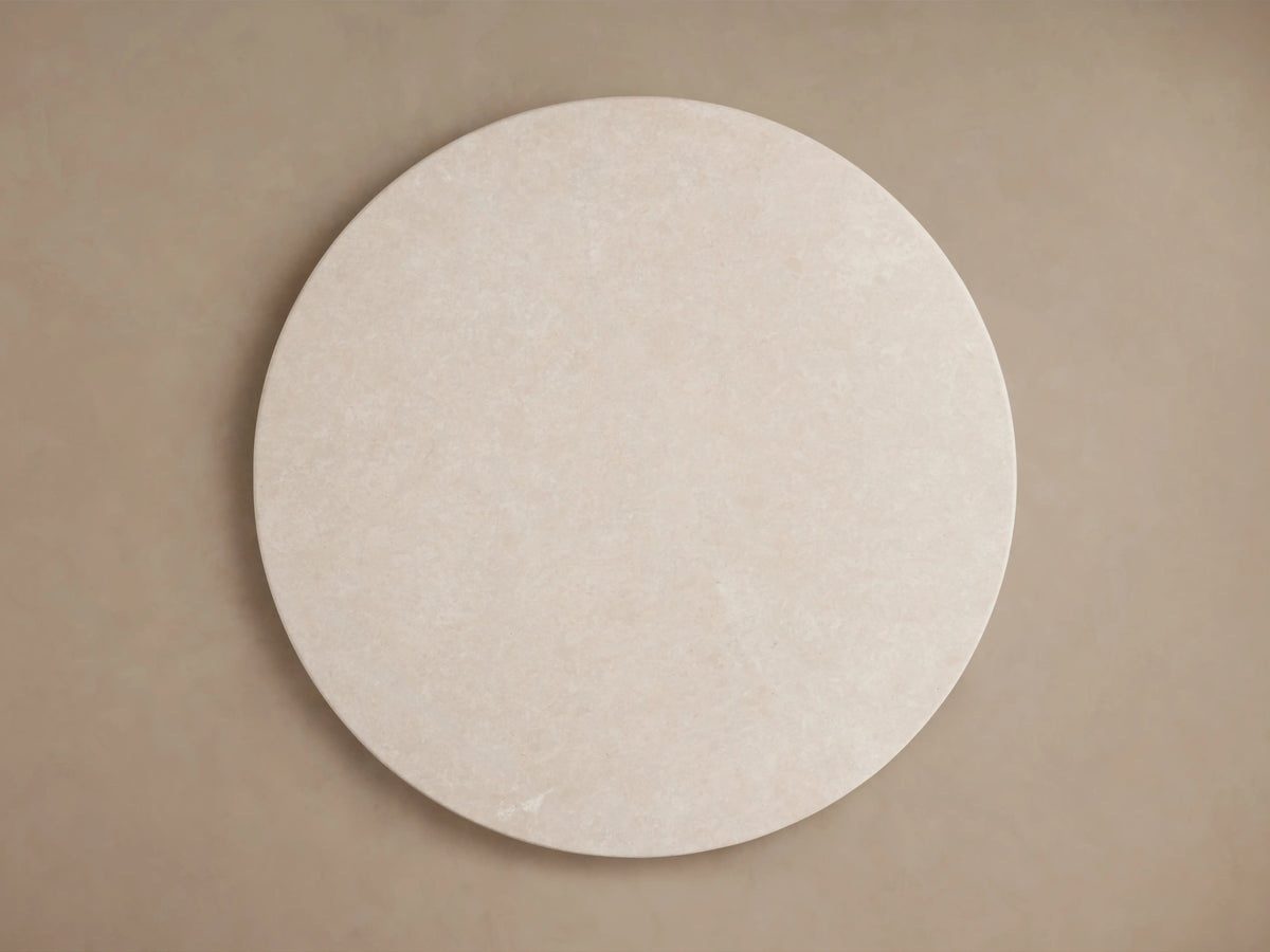 Round tabletop of the Saint Germain Dining Table, showcasing a cream marble surface with natural, subtle variations in color and pattern.
