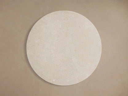 Close-up of the light beige honed stone tabletop of the Saint Germain Round Stone Dining Table with Launette Base.