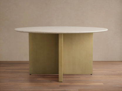 Saint Germain Round Stone Dining Table with a light marble top and an antique brass steel base, placed on a wooden floor.