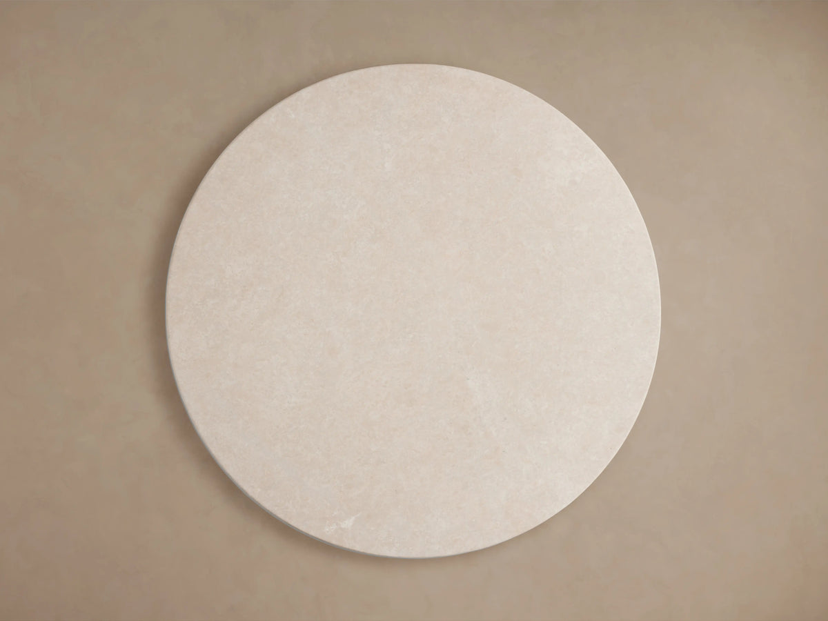 Round cream marble tabletop of the Saint Germain Dining Table, showcasing a smooth, uniform surface against a neutral background.