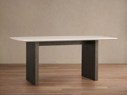 Saint Germain Dining Table with a rectangular Carrara marble top and a dark wood Clement base, set on a wooden floor.