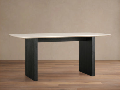 Saint Germain dining table with a cream marble top and solid black wood base, set against a neutral background on a wooden floor.