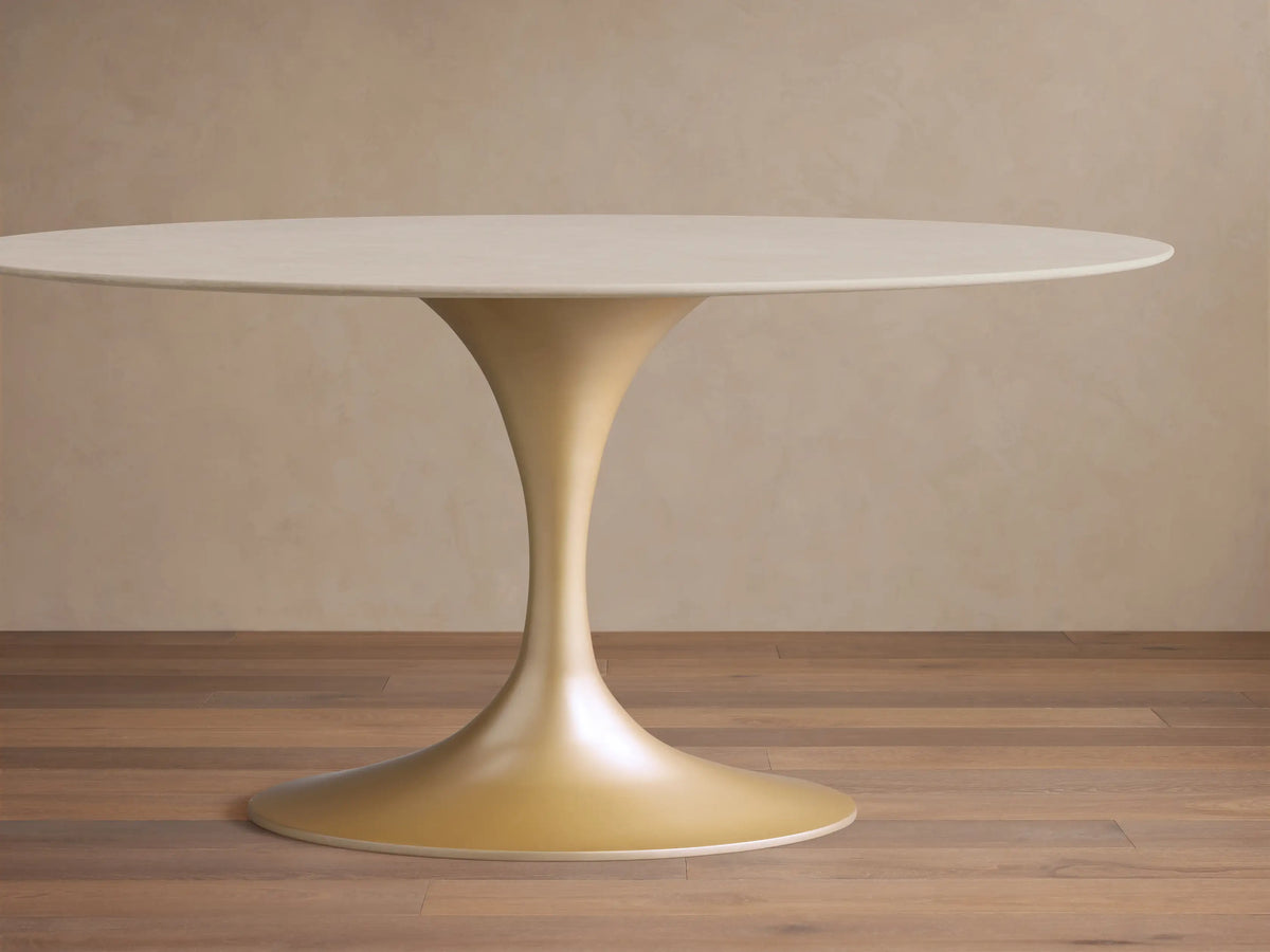 Round Saint Germain Bistro Table with a cream marble top showing subtle veining and a smooth, steel base in a soft gold hue.