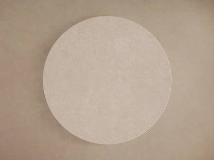 Round table with a cream marble top viewed from above, showing subtle natural variations and patterns on a neutral background.