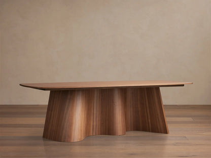 Cortina Dining Table made of American walnut. Features a smooth rectangular top and a unique fluted, wavy pedestal base.