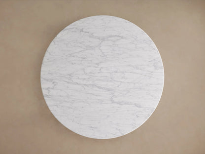 Danae Round Stone Dining Table featuring a smooth, white marble surface with natural gray veining and a fluted base design.