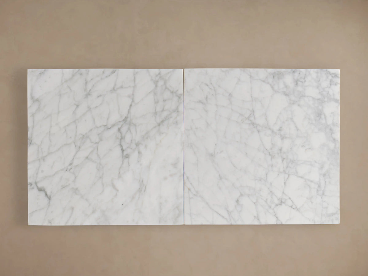 Round marble Danae Dining Table with a clear lacquer finish, showing unique grey veining patterns on a light surface.