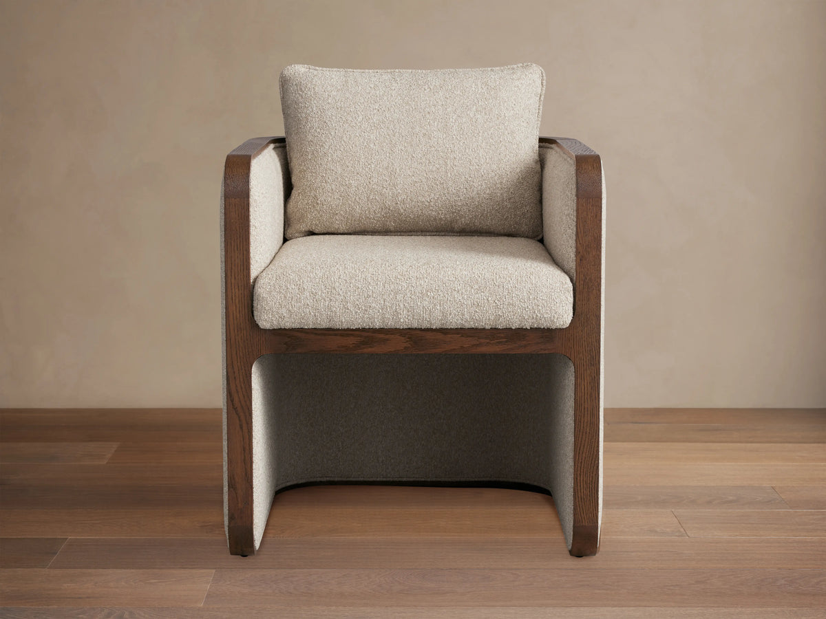 Dempsey Dining Chair in Mocha, oak frame, beige fabric, square shape, plush seat and backrest, on wooden floor.
