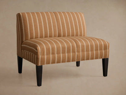 Eaton Bench upholstered in warm brown fabric with light vertical stripes, on four dark, tapered wooden legs. Front view.