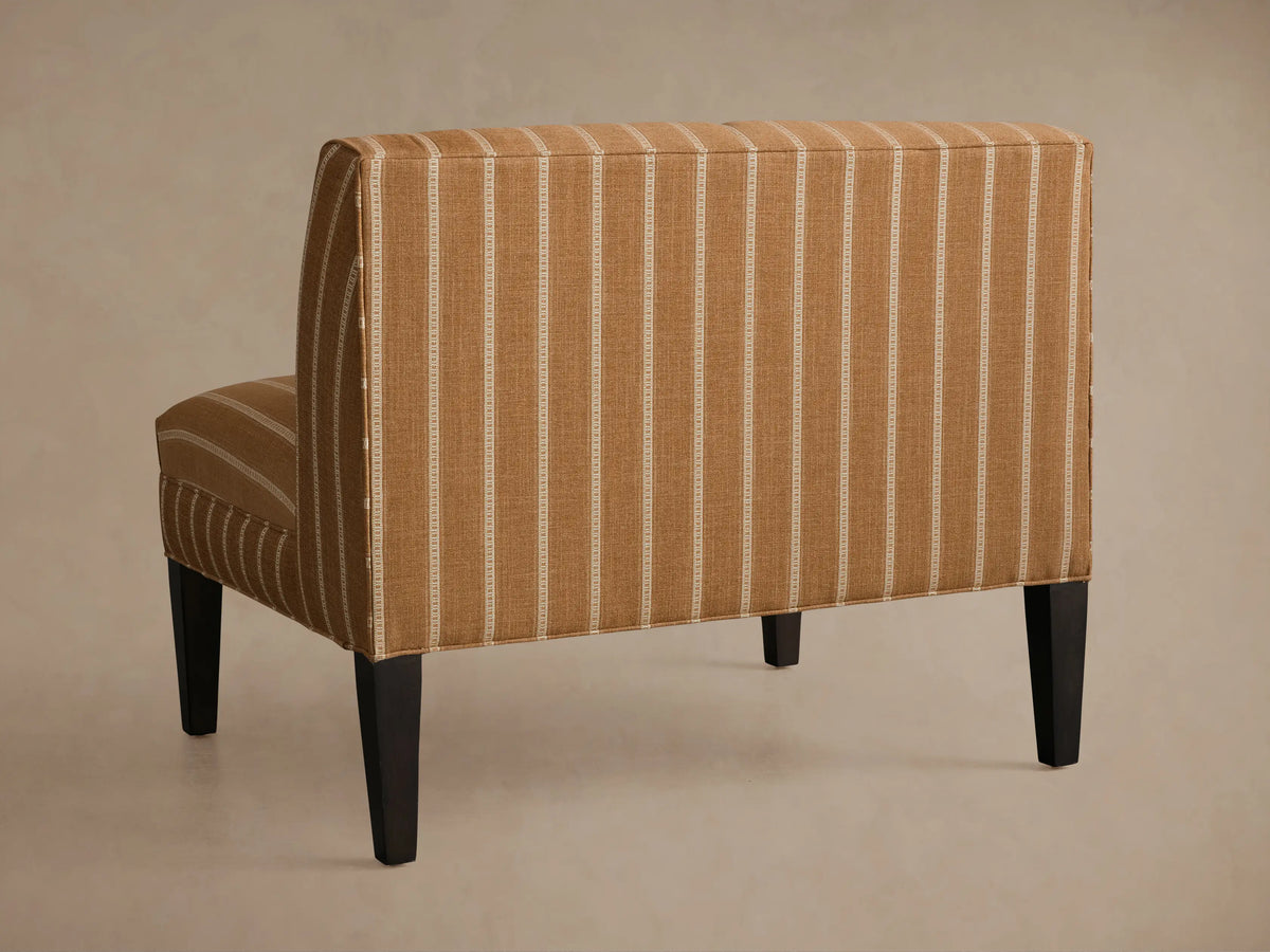 Eaton Bench, upholstered in textured brown fabric with thin white stripes on seat and backrest. Dark leg bottom right.