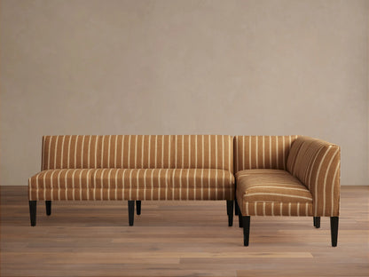 Eaton Banquette, L-shaped, upholstered in brown fabric with vertical white stripes, dark tapered legs, on wood floor.