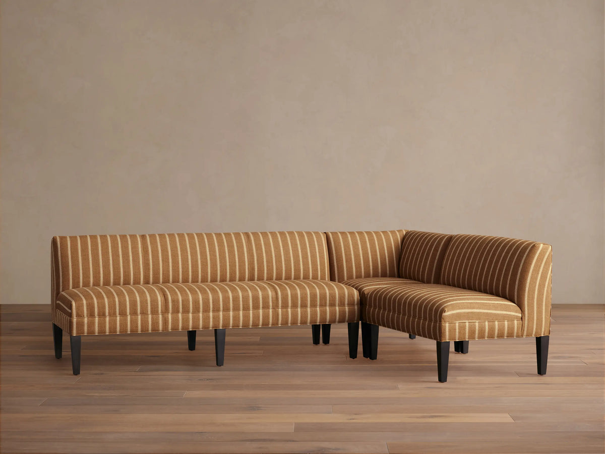 Full view of the L-shaped brown striped Eaton Banquette with channel-stitched backrests in a bright dining nook.