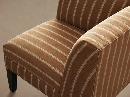 Eaton Corner piece, angled front view, upholstered in brown fabric with light vertical stripes, dark wooden legs on wood floor.
