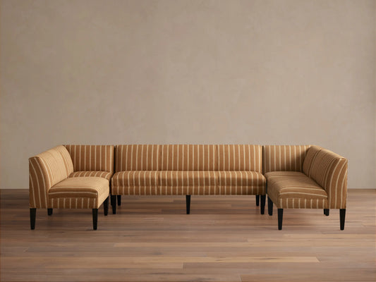 Eaton U-Shaped Banquette in light brown & white striped fabric, U-shaped, with dark tapered legs on a wood floor.