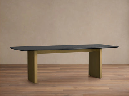 Saint Germain Wood Dining Table with a dark oak tabletop and a rectangular base in a muted bronze finish on a wooden floor.