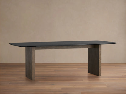 Saint Germain dining table with rectangular dark wood top and sturdy wooden base, placed on a light wooden floor.